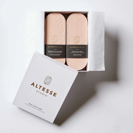 A set of two hairbrushes with olive wood handles, displayed in an open white box with the Altesse Studio brand visible on the box's lid.