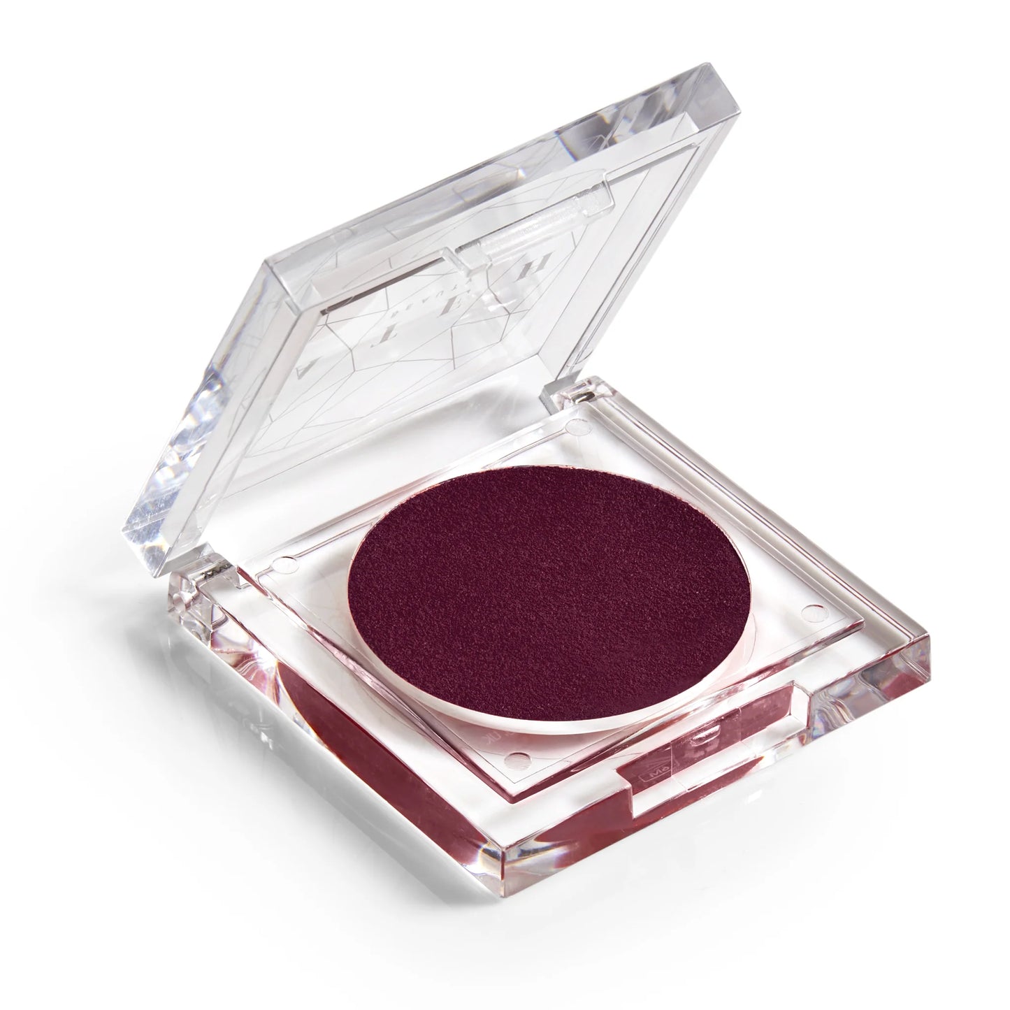 A pan of rich, juicy plum-colored blush makeup with a clear lid.