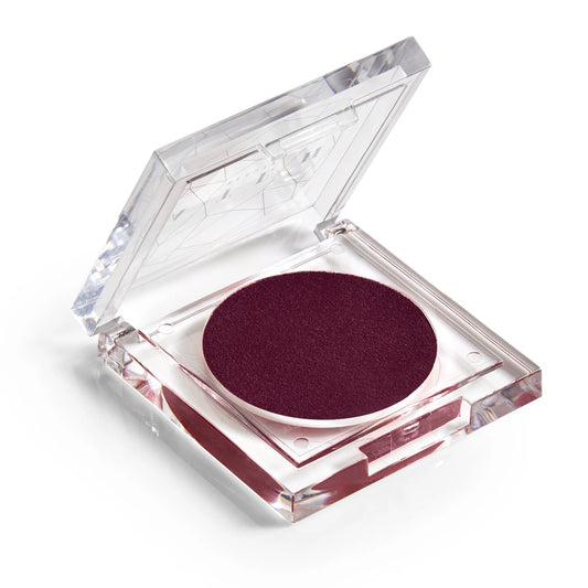 A pan of rich, juicy plum-colored blush makeup with a clear lid.