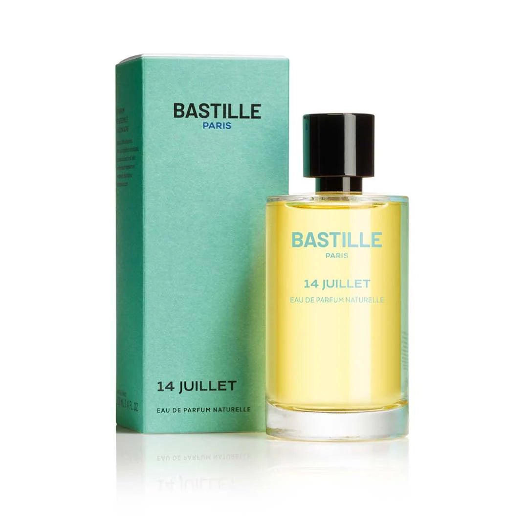 A bottle of 'Bastille 14 Juillet' EDP perfume next to its green box packaging, with the brand and product name visible.