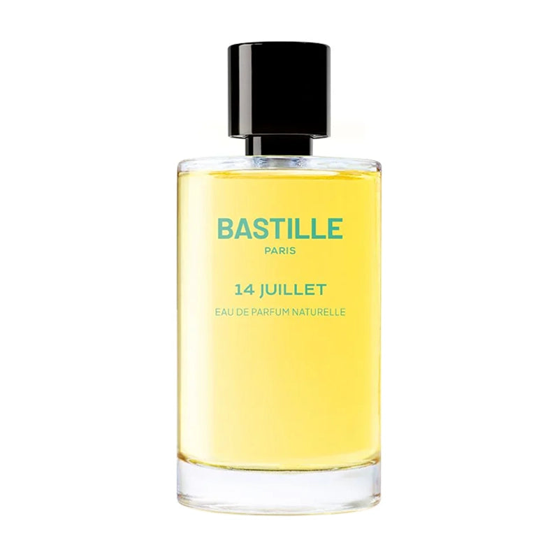 Eau de parfum naturalite by bastille, 14 jullet edition, in a clear glass bottle with a black cap and yellow-toned liquid. The label indicates 'bastille paris' and the fragrance name 'juillet 14'.