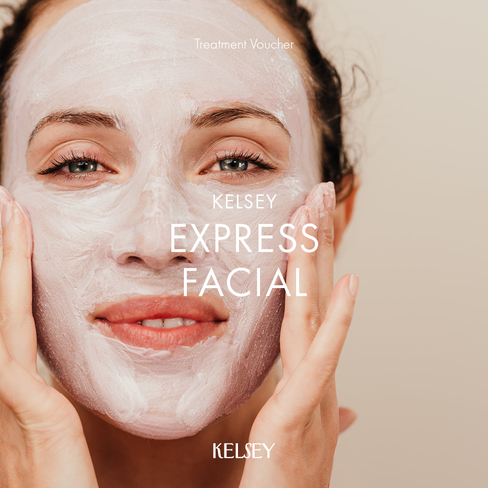 A person with a treatment voucher for a Kelsey Express Facial, with a facial mask applied to their face.