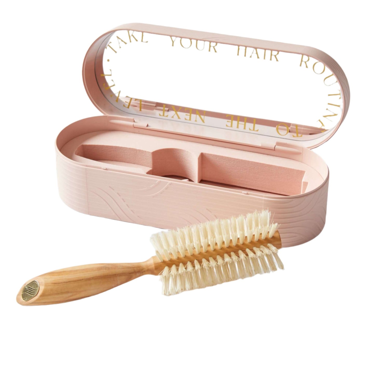 A pink hairbrush with boar bristles is displayed next to its open case, which has a mirror inside. The hairbrush handle is wooden, and the bristles are arranged for hair styling and shine.