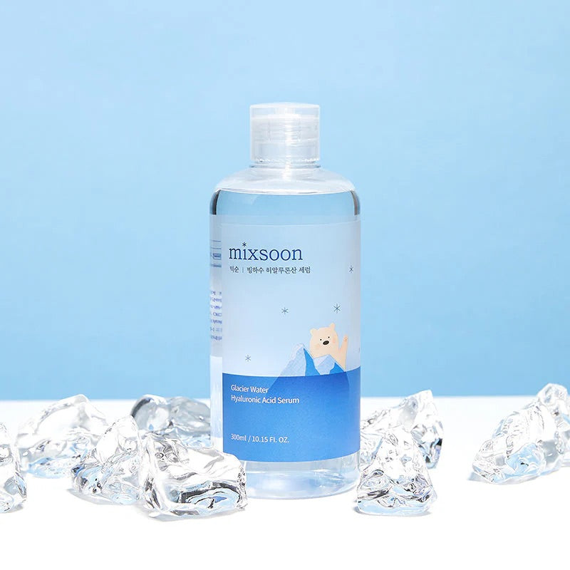 Bottle of mixsoon serum with ice cubes on a light blue background