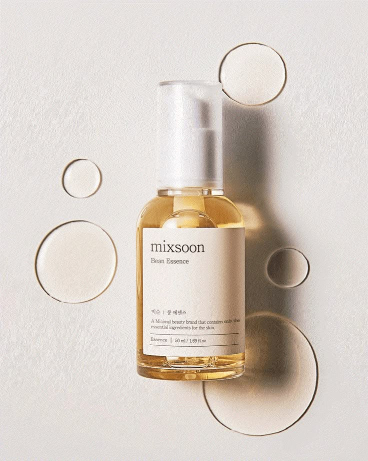 A bottle of Mixsoon Bean Essence skincare product against a light background with circular bokeh effects around it.