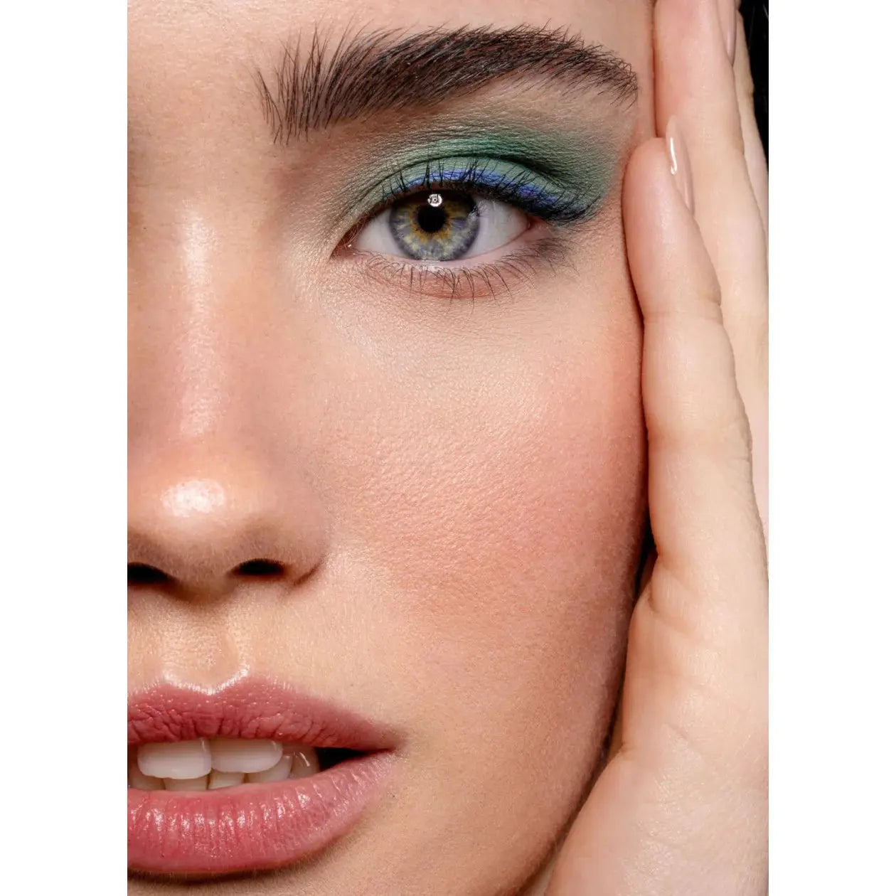 Close-up of a woman's face with makeup, specifically eye shadow.