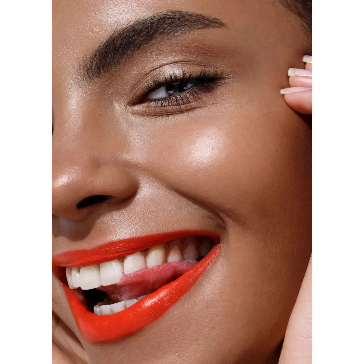 Close-up of a woman's face with bright red lipstick on a white background