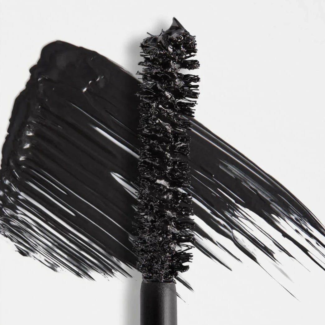 Black mascara wand with bristles on a white background