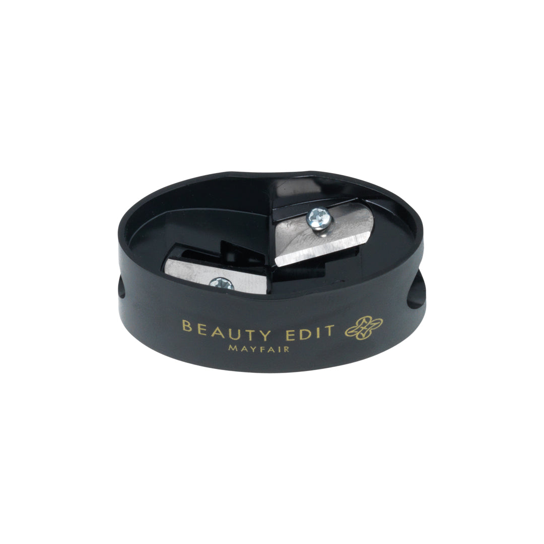 A black, dual-ended makeup pencil sharpener with the Beauty Edit Mayfair brand name on it.
