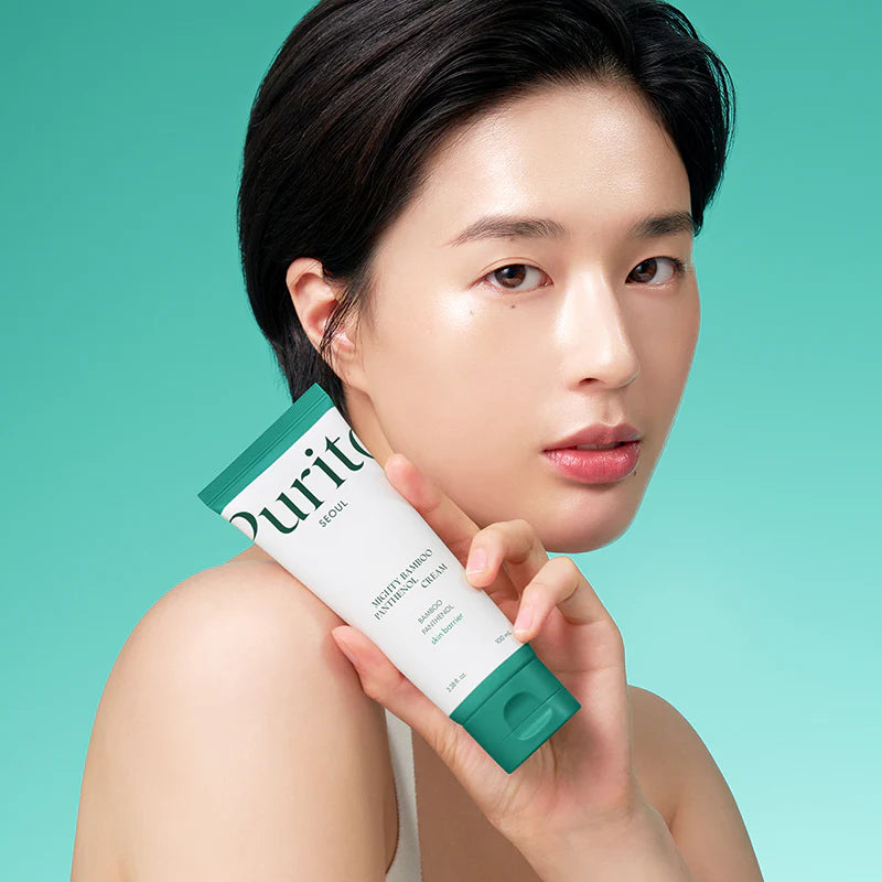 Person holding a skincare product with a green background