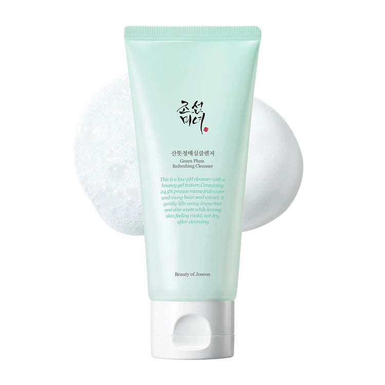 A tube of Beauty of Joseon Green Plum Refreshing Gel Cleanser with a white pump, alongside a cotton pad and a facial cleansing wipe.