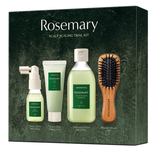 Rosemary scalp scaling trial kit with bottles, scrub, shampoo, and brush on a green background