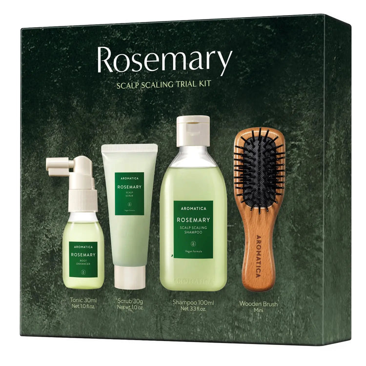 Rosemary scalp scaling trial kit with bottles, scrub, shampoo, and brush on a green background
