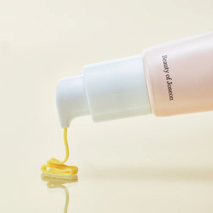 Beauty of Joseon skincare product with yellow cream being squeezed out on a beige background