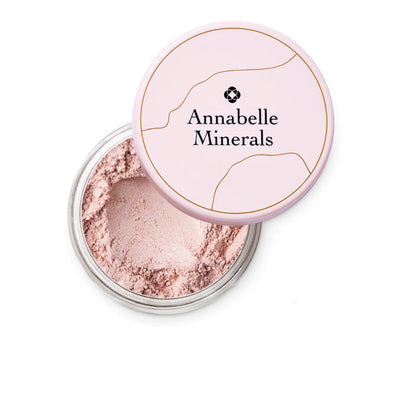 Open container of Annabelle Minerals powder with pink lid on a white background